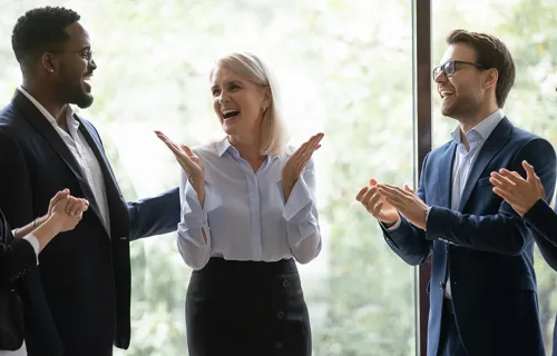 Group of professionals standing and laughing