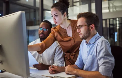 Three colleagues working agiley at a computer