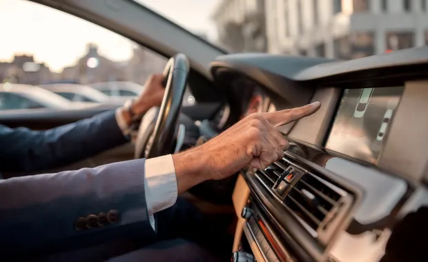 Person using touch screen navigation on dashboard